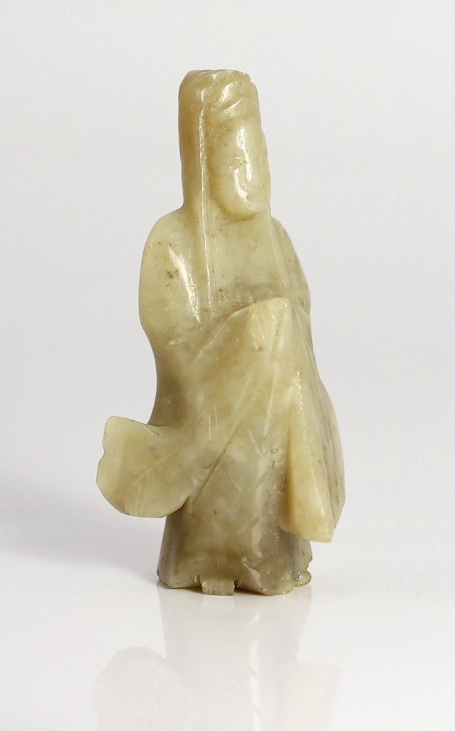 An early Chinese cream jade figure of Guanyin, together with a 19th century pale celadon and brown jade brushrest